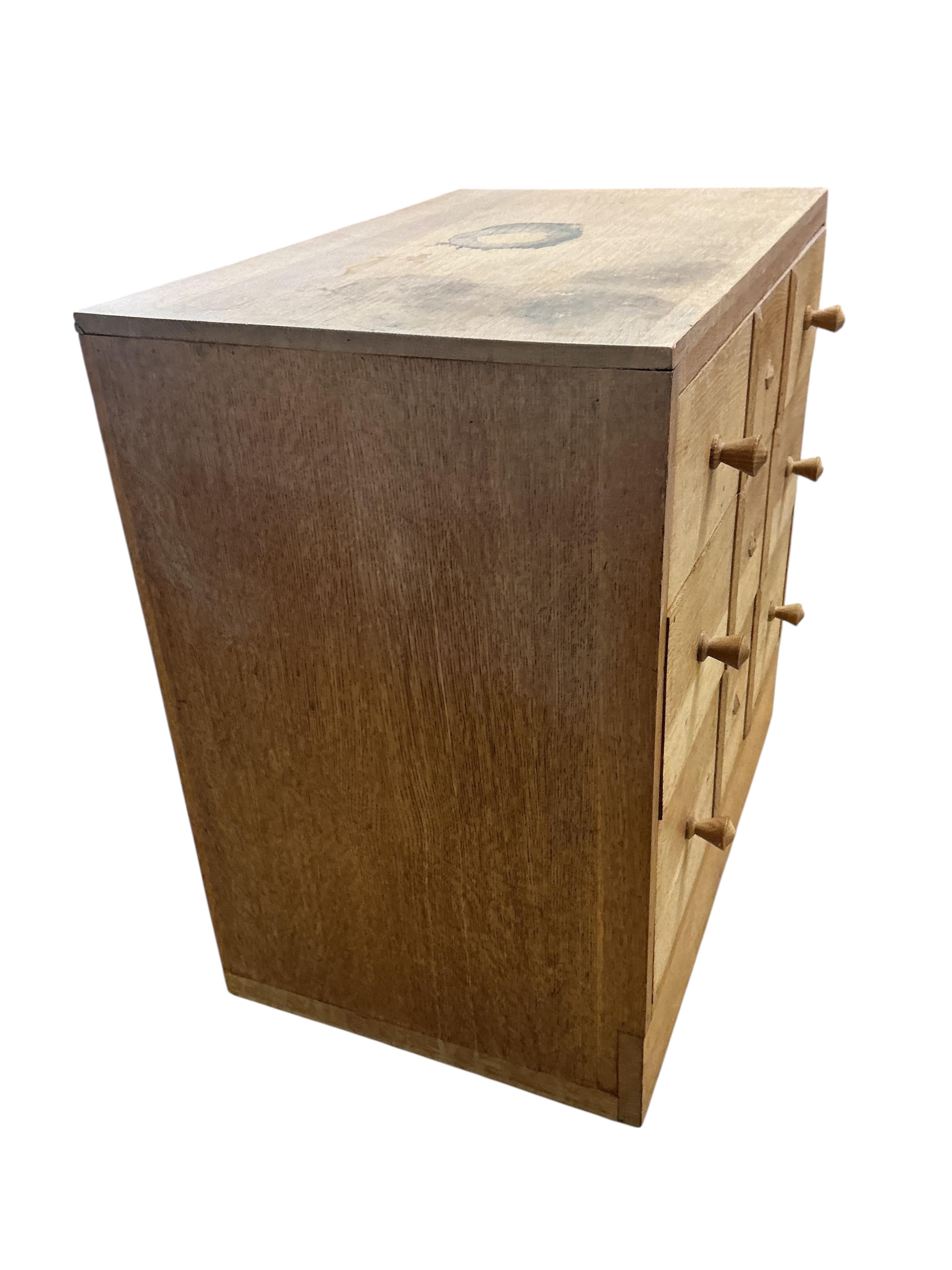 A pair of small limed oak three drawer chests in the manner of Heals, width 68cm, depth 43cm, height 68cm